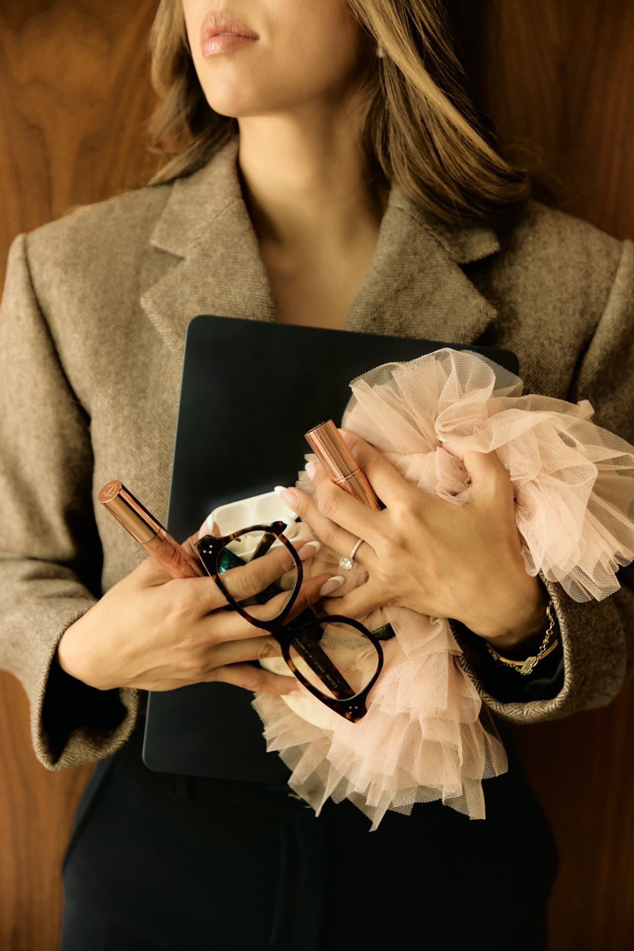 Lisa Nguyen holding her laptop and glasses before a client meeting